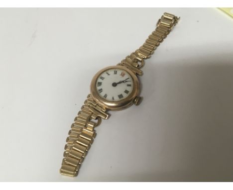 A ladies Vintage 9carat gold cased watch with a gold plated attached bracelet.