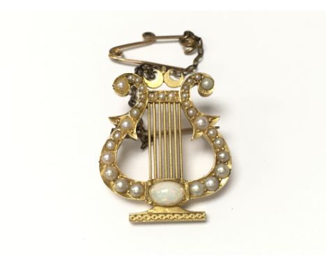 A fine 18ct gold and Opal lyre brooch. Postage Category A.