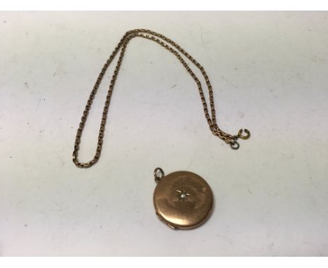 A 9ct gold oval locket with chain set with an old cut diamond. Approx 10.14 grams.