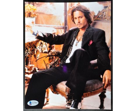 Johnny Depp - Pirates Of The Caribbean - autographed 8x10" photograph of Depp in a seated pose. Signed by Depp in black ink t