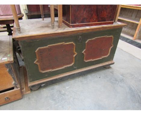 A 19th Century Continental painted pine storage trunk with shaped panel mouldings and turned bun feet 
