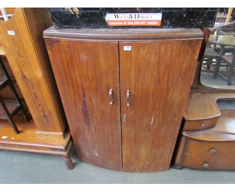 A 1950s walnut bow fronted diminutive two door wardrobe, 133cm high