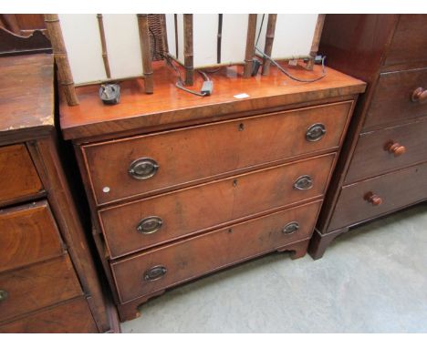 A Georgian flame mahogany split chest of three drawers on bracket feet 
