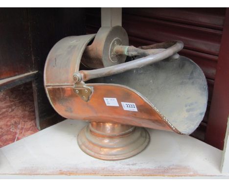 A copper coal helmet and scoop 