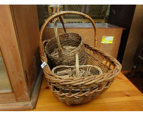 A wicker picnic basket containing vintage clothes pegs
