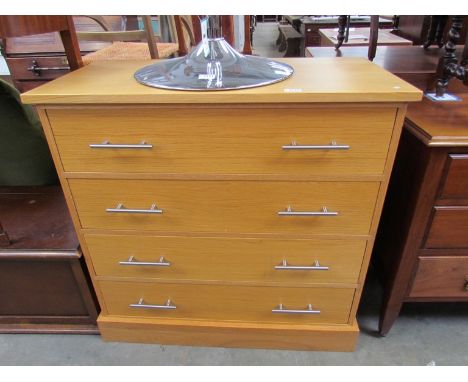 A modern light oak four drawer chest 
