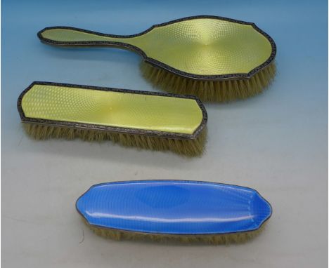 Three silver and enamel backed brushes