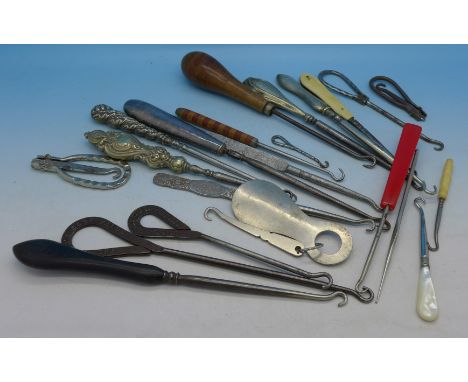 A collection of button hooks including silver handled and advertising