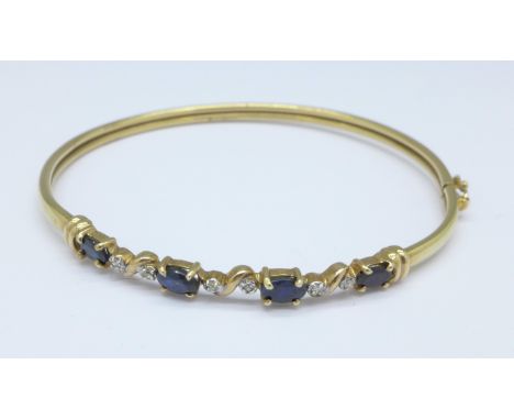 A 9ct gold, diamond and sapphire bangle, 4.5g
