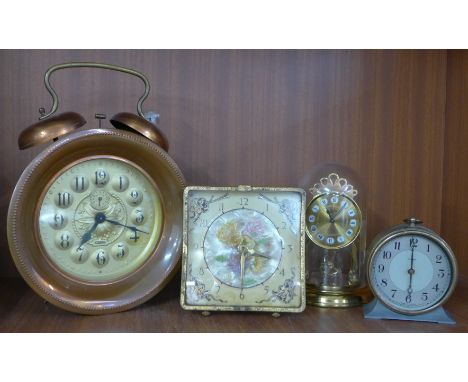 A large alarm clock and three other clocks