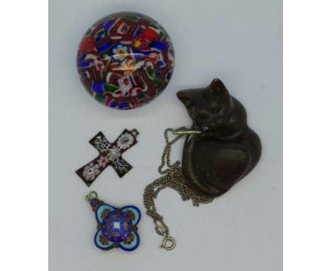A paperweight, a millefiori cross pendant, a carved cat pendant and an enamel pendant