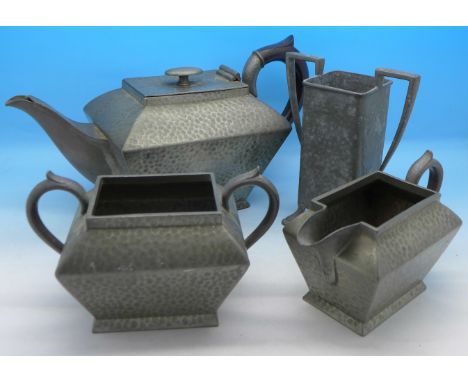 A hammered pewter Arts and Crafts four-piece tea service by Civic England