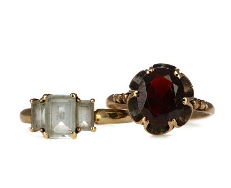 TWO GEM SET RINGS, comprising a nine carat gold garnet ring, size M and a gem set three stone ring, in nine carat gold, size 