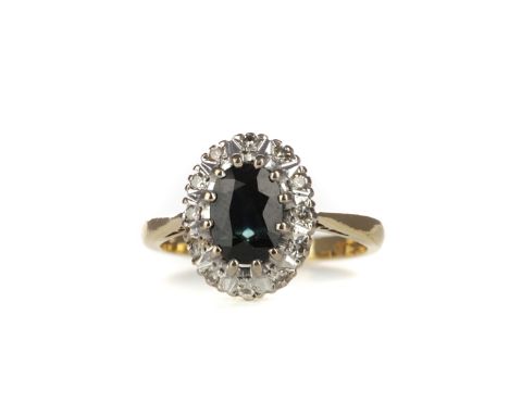 SAPPHIRE AND DIAMOND RING, set with a central sapphire within an illusion set diamond halo, the diamonds totalling approximat
