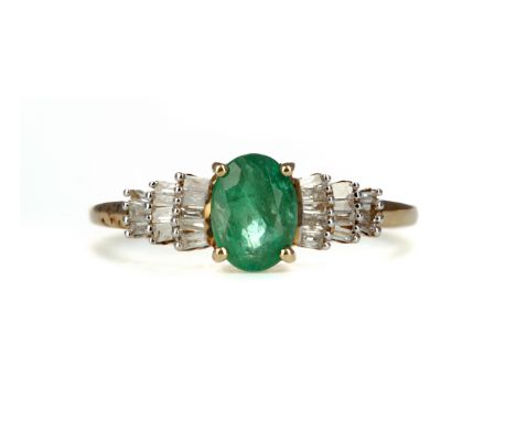 EMERALD AND DIAMOND RING, set with an oval emerald on tiered baguette cut diamond shoulders, marked 9K, size O, 1.9g