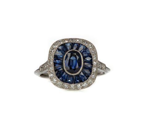 SAPPHIRE AND DIAMOND RING, set with an oval sapphire within a double sapphire and diamond halo, on diamond shoulders, unmarke