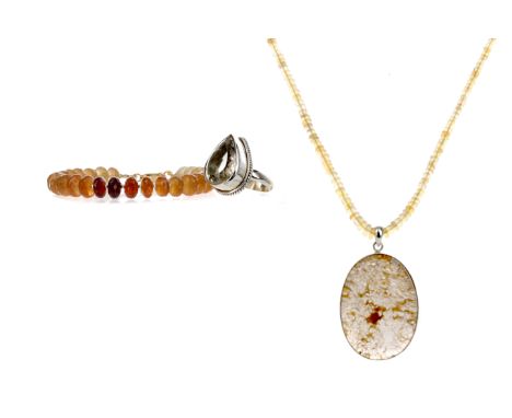 ETHIOPIAN BEAD NECKLACE, formed by smooth beads, with large silver mounted pendant, 46 - 50cm long, along with a faceted hess