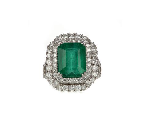 EMERALD AND DIAMOND RING, set with an emerald cut emerald of approximately 4.87 carats, within a double halo of round brillia