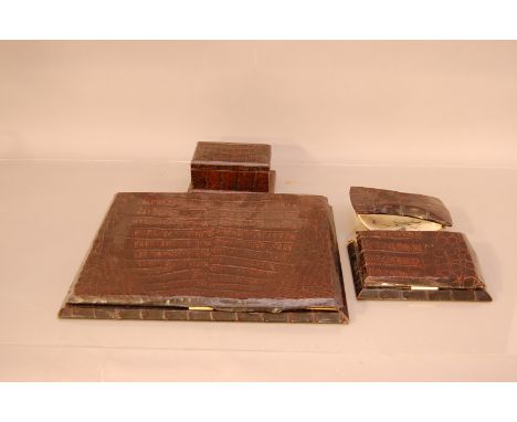 A group of c.1960's crocodile skin desk items, comprising a large hinged blotter (AF), 31cm x 40cm, with a smaller one, a rol