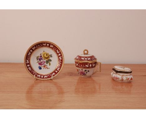 A late 19th century Augustus Rex porcelain hot chocolate cup and saucer, angular handle, the cup lid with gilt finial, floral