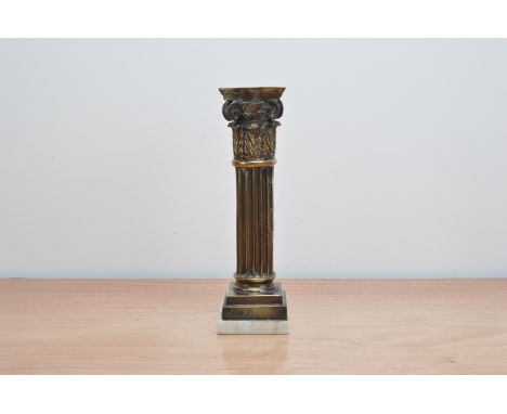 A bronzed neoclassical candlestick,  rasied on a steped base (indistinctly signed) on a marble base, 27cm high