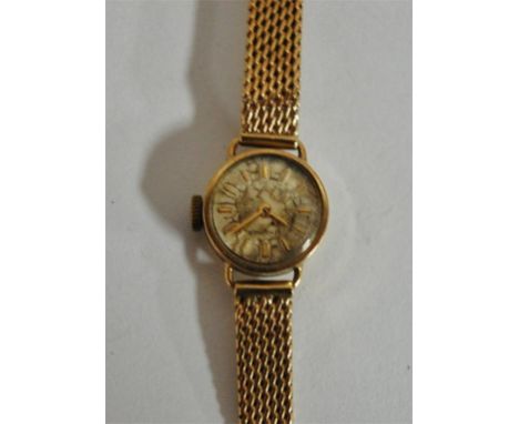 A circa 1960s Longines ladies 9ct gold bracelet watch having manual wind movement, signed silver dial, and mesh link bracelet