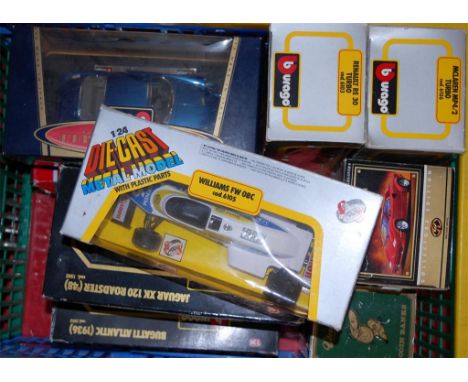 A collection of assorted boxed diecast toy vehicles to include; Burago 1/24 scale model of a Jaguar XK120 Roadster etc 