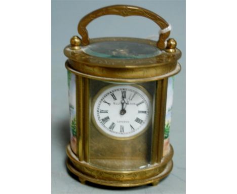 A reproduction miniature brass cased carriage clock with inset porcelain panels and platform lever escapement