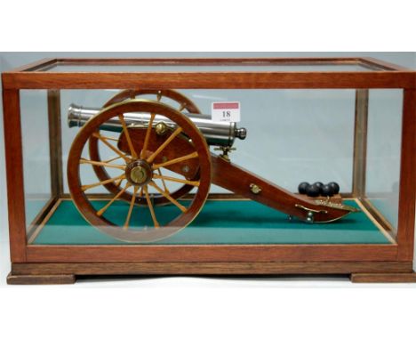 A cased hardwood and steel scale model of a cannon with balls, case w.45cm 