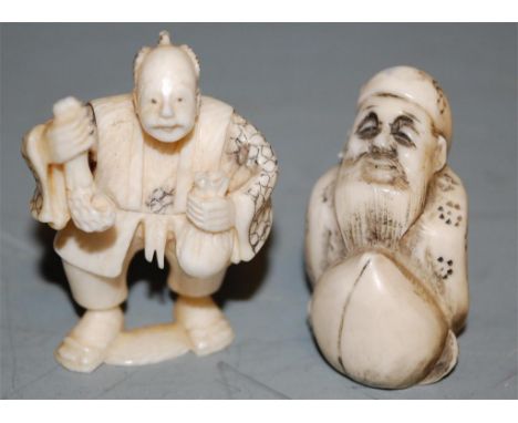 An early 20th century ivory netsuke carved as a man in standing pose, signed verso, together with another (2) 