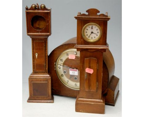 An Art Deco oak cased striking and chiming mantel clock, a mahogany and inlaid miniature longcase clock case (lacking dial wa