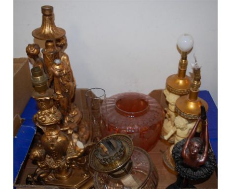 A reproduction figural oil lamp with glass reservoir and tinted glass shade together with a pair of modern resin figural tabl