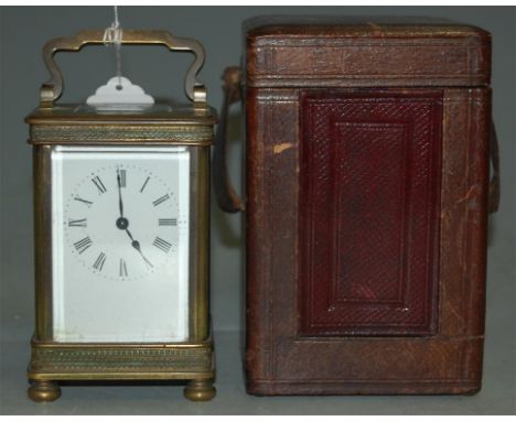 An early 20th century brass cased carriage clock, having white enamel dial with Roman numerals and platform lever escapement,