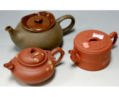 A Chinese Xing teapot, and one other, and a Chinese stoneware undecorated teapot (3)