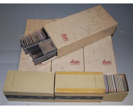 A box of assorted cinematic projector slides, together with various glass slides