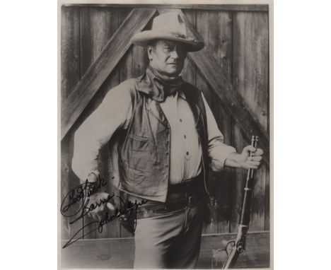 WAYNE JOHN: (1907-1979) American Actor, Academy Award winner. Signed and inscribed 8 x 10 photograph of Wayne standing in a t