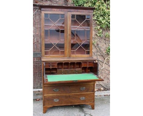 Georgian Secretaire book case, astragal glazed and standing upon its original bracket feet. Adjustable shelves to upper porti