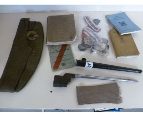 A selection of World War Two cloth badges with soldiers side hat, Officers service documents, small arms manual, two bibles a