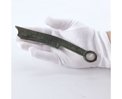 Chinese Warring States Period Qi State three-character bronze knife coin. This large knife coin with a raised border rim, in 