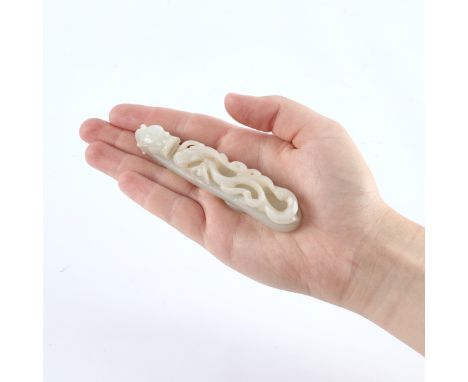 Chinese delicately carved pale celadon jade belt hook in the form of a dragon. With a silk box.(Jade) Height: 3/4 in x width: