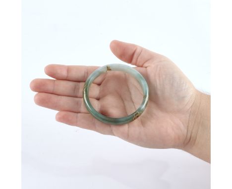 Chinese jadeite jade bangle with gold inlay depicting flowers and a peach.Diameter: 70 mm; weight: 40 g.
