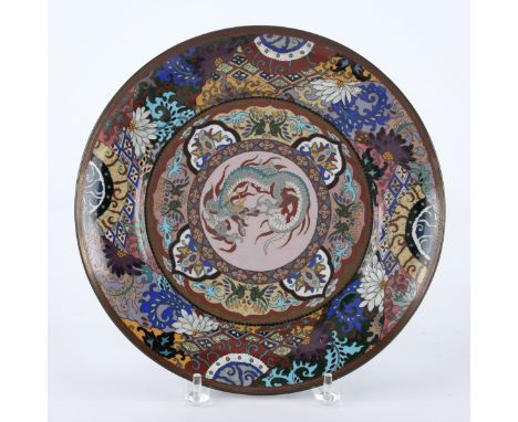 Japanese Meiji cloisonne platter depicting a dragon in the center surrounded by tiered floral and foliate motifs. The undersi