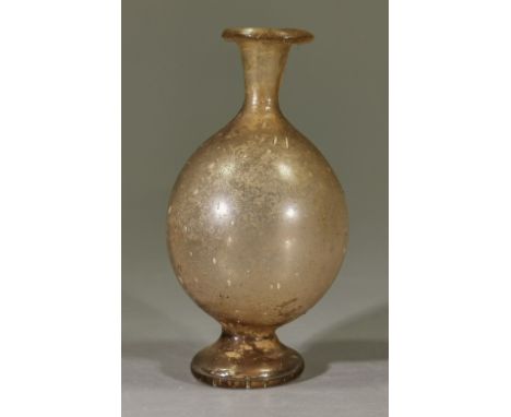 Ca.200 AD. Amazing Roman glass flask with a bulbous body,, thin neck ending in a flared mouth, with pedestal base. Good Condi