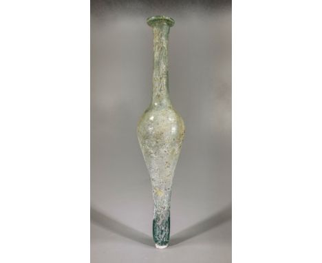 Ca.100 AD. A tall amber-hued glass vessel, free-blown and tubular in form, with a small protruding bottom section and a bulb-