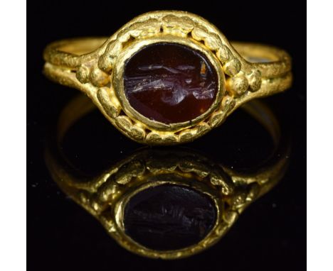 Ca.200 AD. Wearable Roman gold intaglio ring, It is set with its original dark red carnelian gemstone, simply cut with a styl