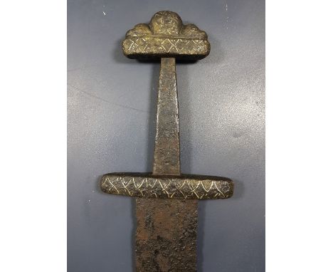 Mid-10th century AD. A hand-forged Viking iron sword with three-lobe pommel and decorated guard; the blade is wide at the upp