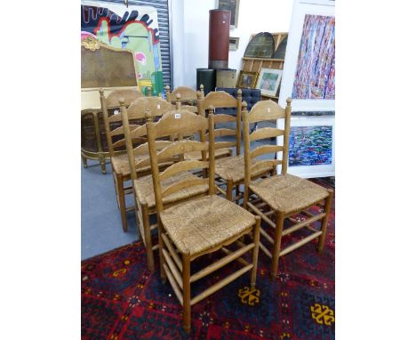 A SET OF SIX ASH RUSH SEATED LADDER BACK CHAIRS.