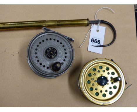 AN UNUSUAL FISHING GAFF WITH COMBINED SPRING SCALE, UNSIGNED TOGETHER WITH A J W YOUNG REEL AND ONE OTHER.  (3)