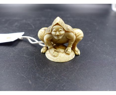 A JAPANESE IVORY NETSUKE CARVED AS A MAN SQUATTING LEANING WITH HIS HANDS ON HIS STRAW HAT, SIGNED.   W.3.5CMS.