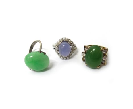 A diamond oval jade set ring, an oval jade solitaire ring, in a sprung setting and a lilac coloured jade and cultured pearl s